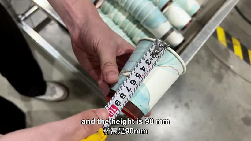 Measuring the 90 mm height of the printed double wall paper cup