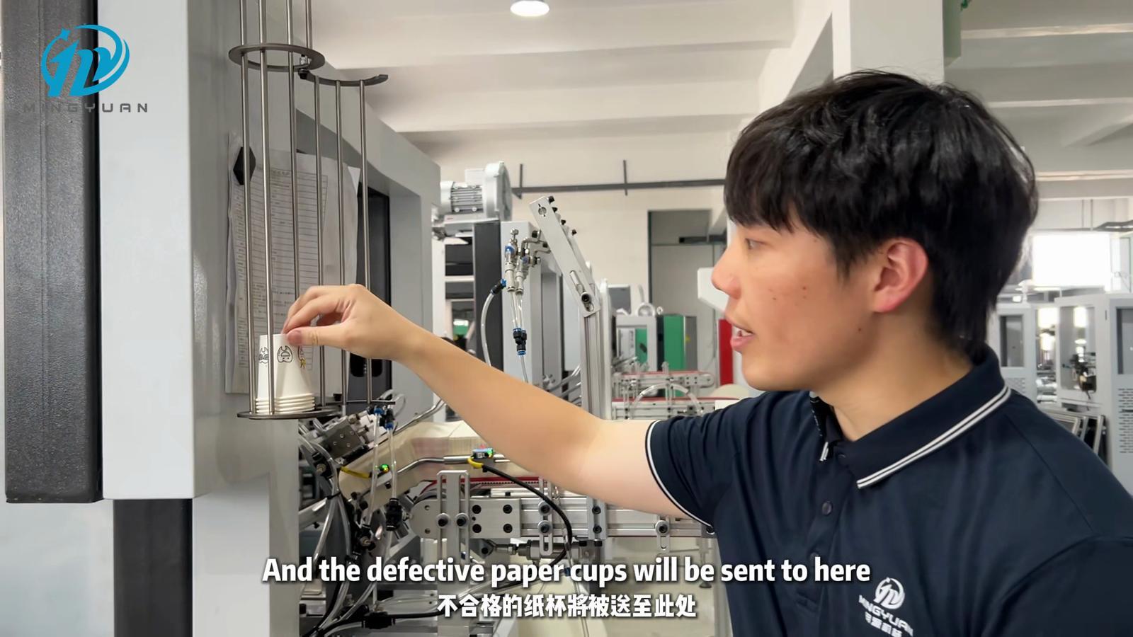 Presenter indicating the outlet for rejected paper cups